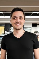 AI generated headshot photograph of a man wearing a v-neck in showroom