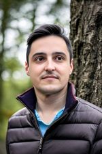 AI generated headshot photograph of a man wearing a jacket in the forest
