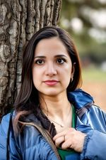 AI generated headshot photograph of a woman wearing a jacket in the forest