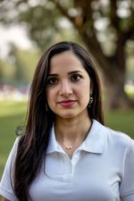 AI generated headshot photograph of a woman wearing a polo in the park